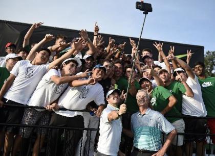 Rory McIlroy uses a selfie stick to take a photo with many of the 54 golfers at the Junior Invitational golf tournament, after speaking to them following the second round at Sage Valley Golf Club in Graniteville, S.C., on Friday, April 24, 2015. (Jon-Michael-Sullivan/The Augusta Chronicle via AP)