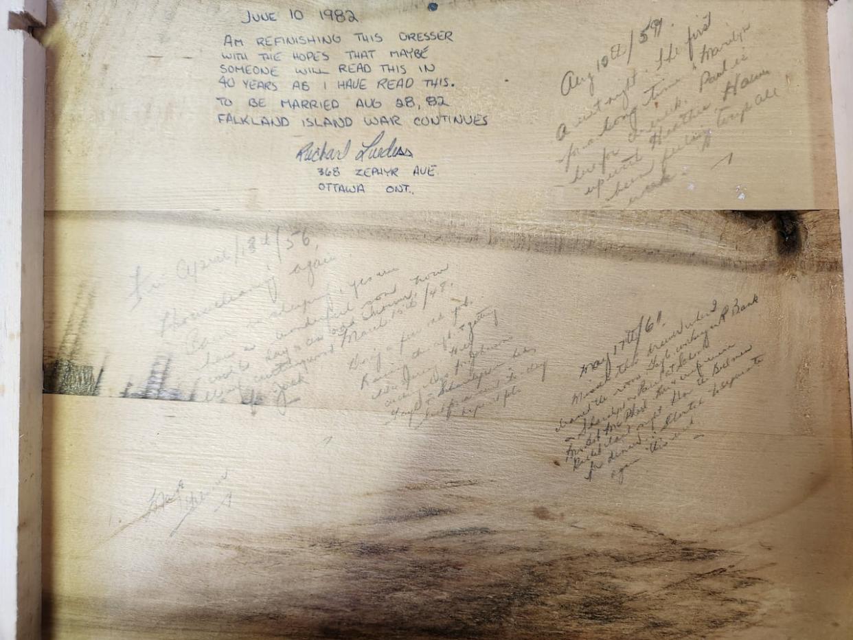 Message in a bureau: Handwritten notes left behind by previous owners cover the underside of a small dresser drawer. They were inscribed in 1948, 1951, 1956, 1961 and 1982.  (Submitted by Tim Skelly - image credit)