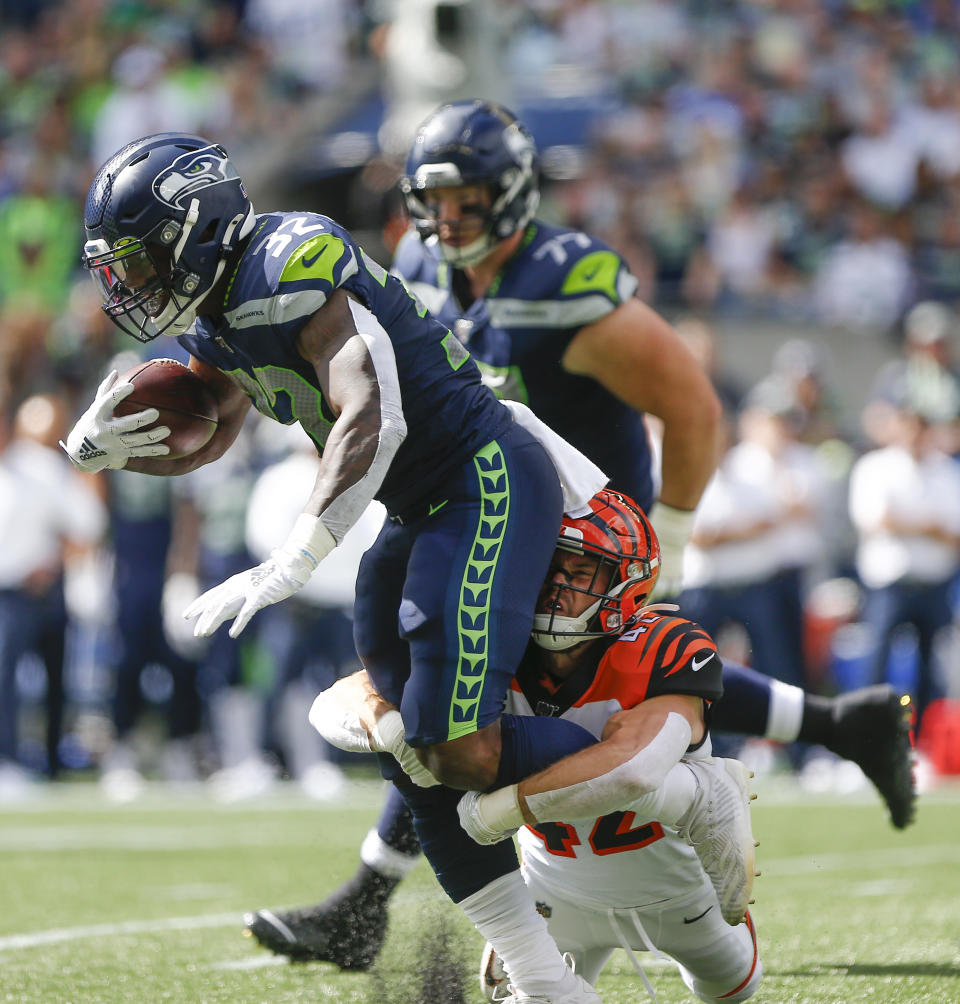 Chris Carson #32 of the Seattle Seahawks is tacked by Clayton Fejedelem #42 of the Cincinnati Bengals in the first quarter at CenturyLink Field on September 8, 2019 in Seattle, Washington. (Photo by Lindsey Wasson/Getty Images)