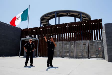 Customs and Border Patrol Port Director for San Ysidro Sidney Aki (R) speaks to the media during tour of the new pedestrian port of entry from Mexico to the United States in San Ysidro, California, U.S. June 30, 2016. REUTERS/Mike Blake/File Photo