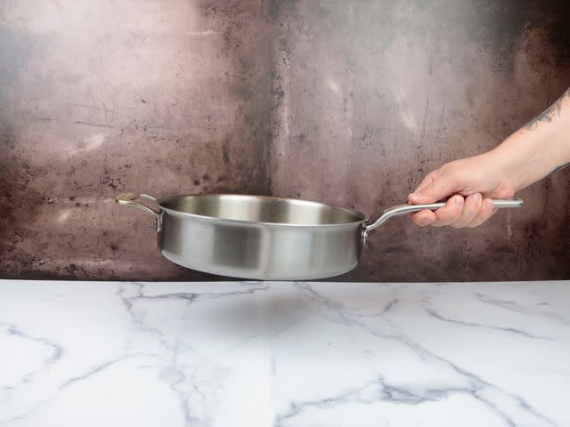 <p>Serious Eats / Jesse Raub</p> The slightly offset handle of the Made In pan was comfortable to grasp and made it easy to hold the pan level.
