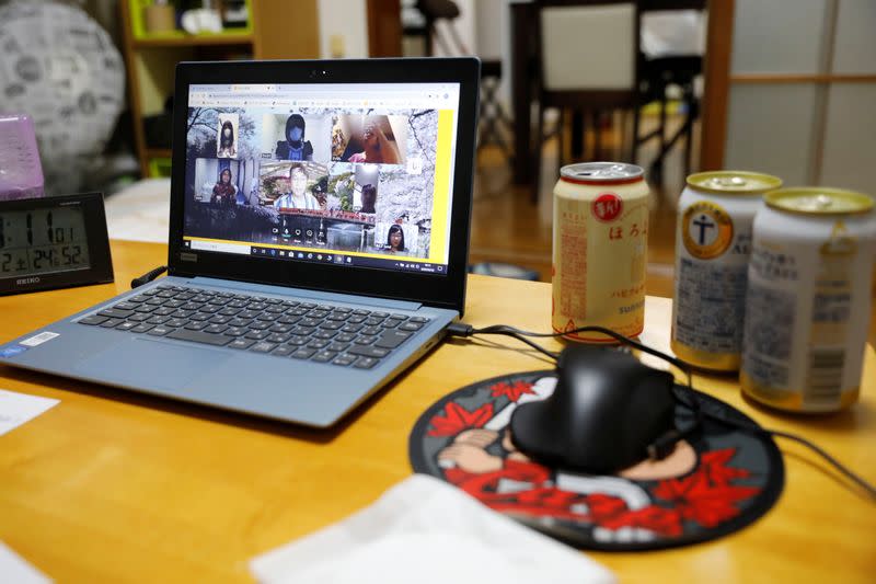 Participants of online drinking party service "Tacnom" are seen on laptop screen in Yokohama