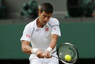 Novak Djokovic of Serbia hits a shot during his match against Bernard Tomic of Australia at the Wimbledon Tennis Championships in London, July 3, 2015. REUTERS/Suzanne Plunkett