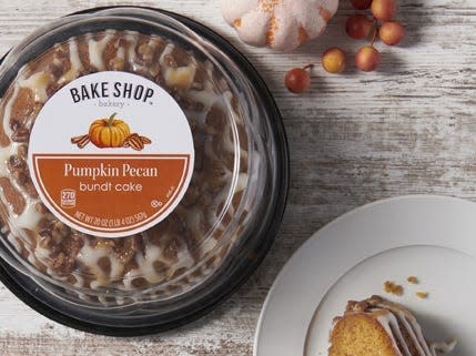 Aldi's Bake Shop Pumpkin-Pecan bundt cake on a table with pumpkin and berry decoration and pecans