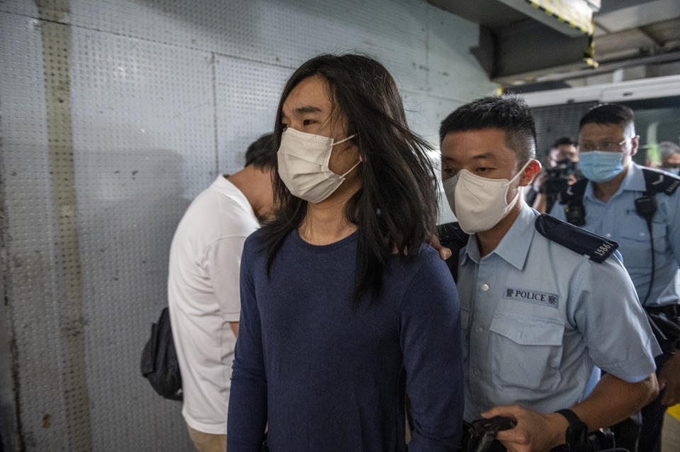 Police officers escorting a man believed to be Tsang Chi-kin at the Distict court on July 14, 2022 in Hong Kong, China. Tsang Chi Kin, who was shot by Police Officers during the 2019 protest that rocked Hong Kong was arrested by Police last night in Sai Kung Distict, The Court issued a warrant for Mr Tsangs arrest after he was set to failed to appear in court last December on one count of rioting and two count of assaulting police officers. (Photo by Vernon Yuen/NurPhoto via Getty Images)