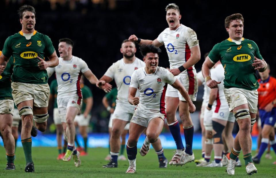 England players show their delight at the final whistle after beating the Springboks at Twickenham (AFP via Getty Images)