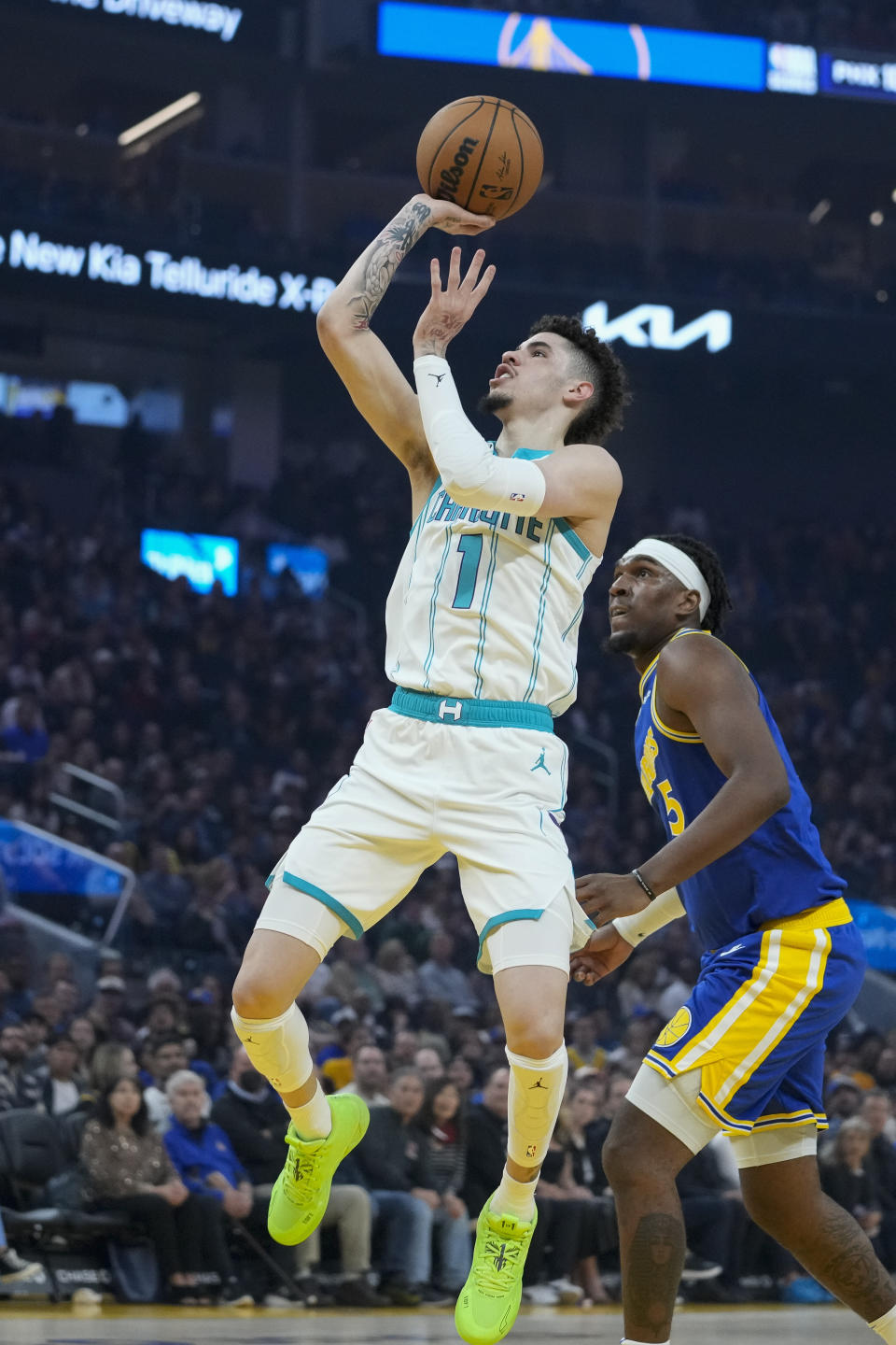 Charlotte Hornets guard LaMelo Ball (1) shoots next to Charlotte Hornets center Mark Williams during the first half of an NBA basketball game in San Francisco, Tuesday, Dec. 27, 2022. (AP Photo/Godofredo A. Vásquez)