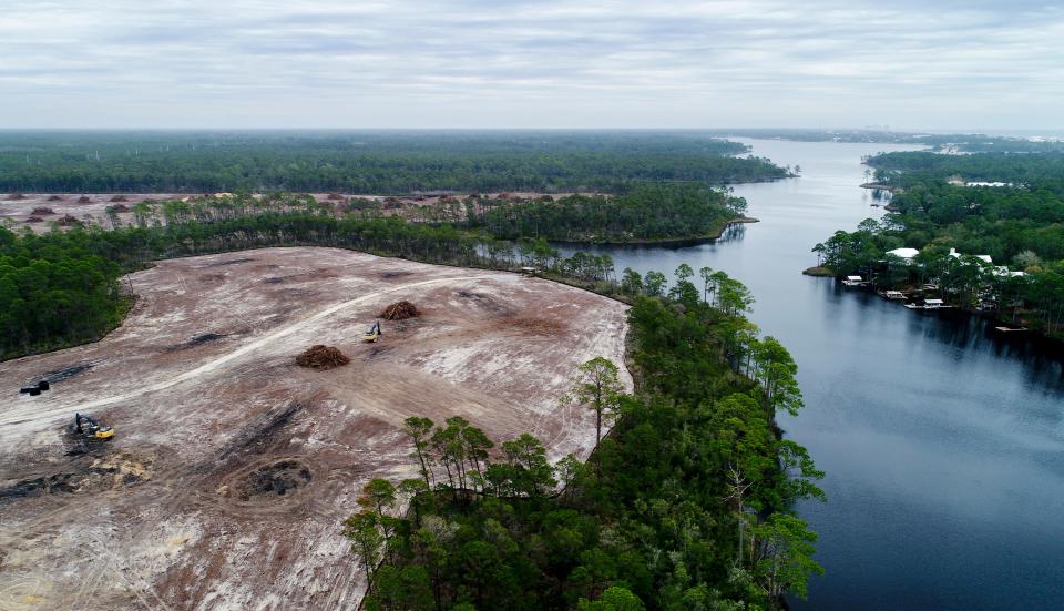 An aerial photo shows land cleared for the St. Joe Co. Watersound Origins residential development next to Lake Powell at the Walton-Bay County line.