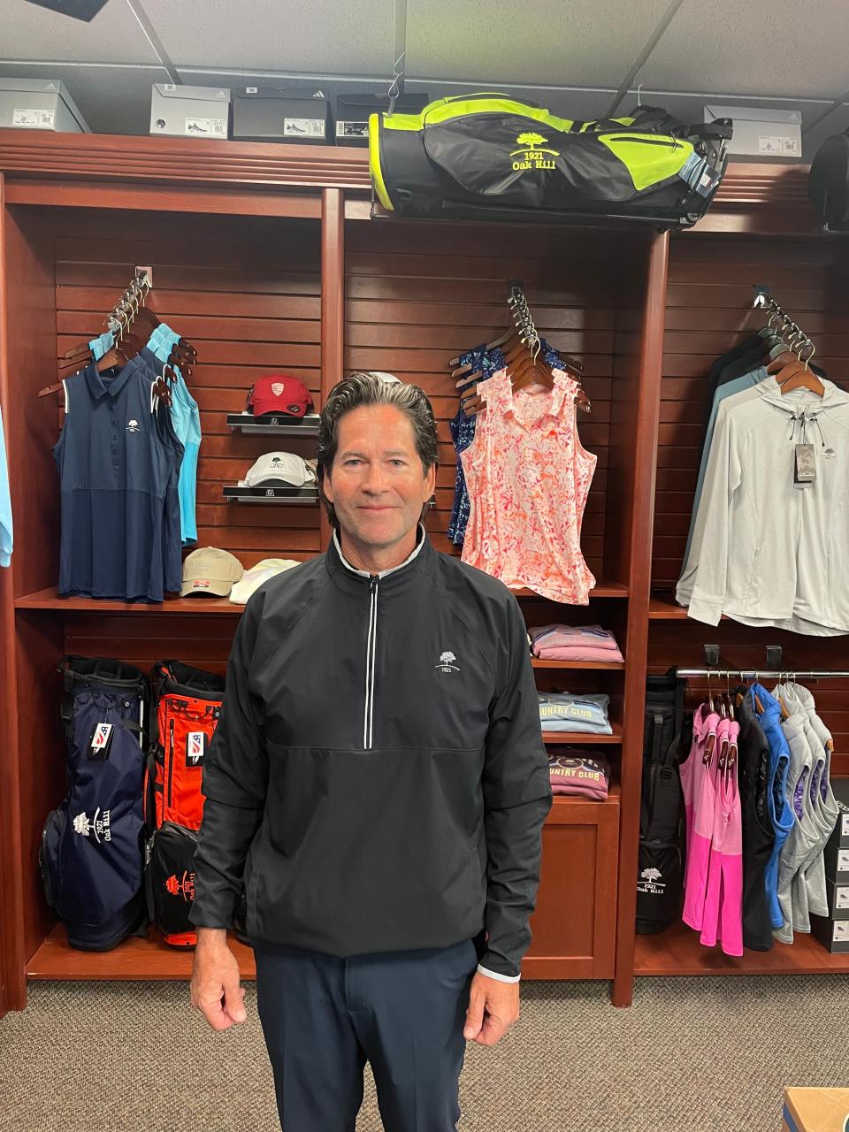 Assistant pro Mike Elliott stands in the pro shop at Oak Hill Country Club.