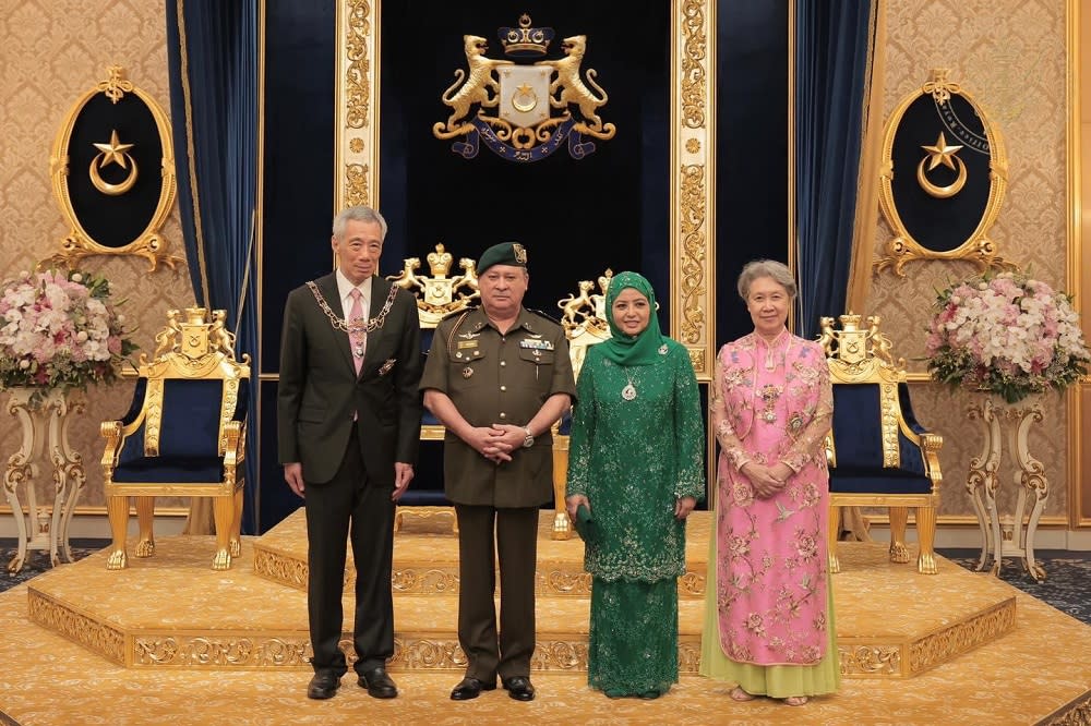 Johor Ruler Sultan Ibrahim Sultan Iskandar and his consort Permaisuri of Johor Raja Zarith Sofiah Sultan Idris Shah flanked by Singapore PM Lee Hsien Loong and his wife Ho Ching after the special investiture ceremony held at the Istana Besar in Johor Baru May 6, 2022. — Picture courtesy of Johor Royal Press Office (RPO)