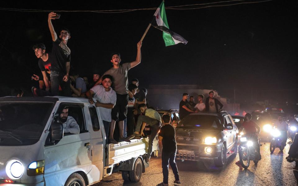 Drivers honked their horns as their passengers waved Syria's flag in celebration