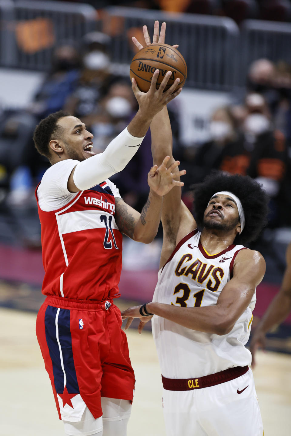 Washington Wizards' Daniel Gafford (21) shoots over Cleveland Cavaliers' Jarrett Allen (31) during the second half of an NBA basketball game, Friday, April 30, 2021, in Cleveland. (AP Photo/Ron Schwane)