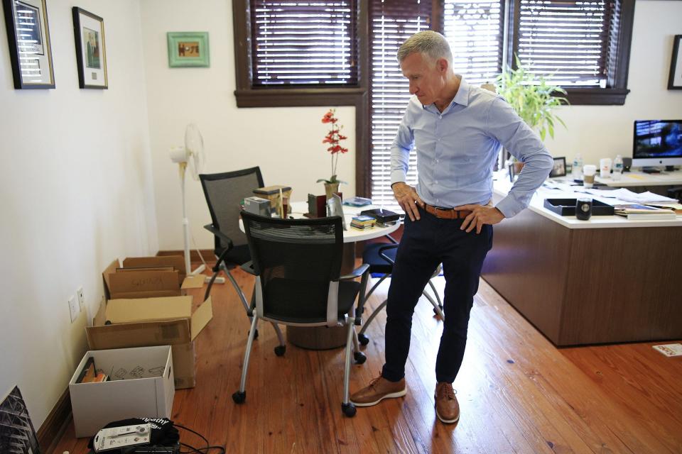 Founder and CEO Kevin Gay surveys his packing boxes at Operation New Hope in Jacksonville. Gay is retiring after 23 years.