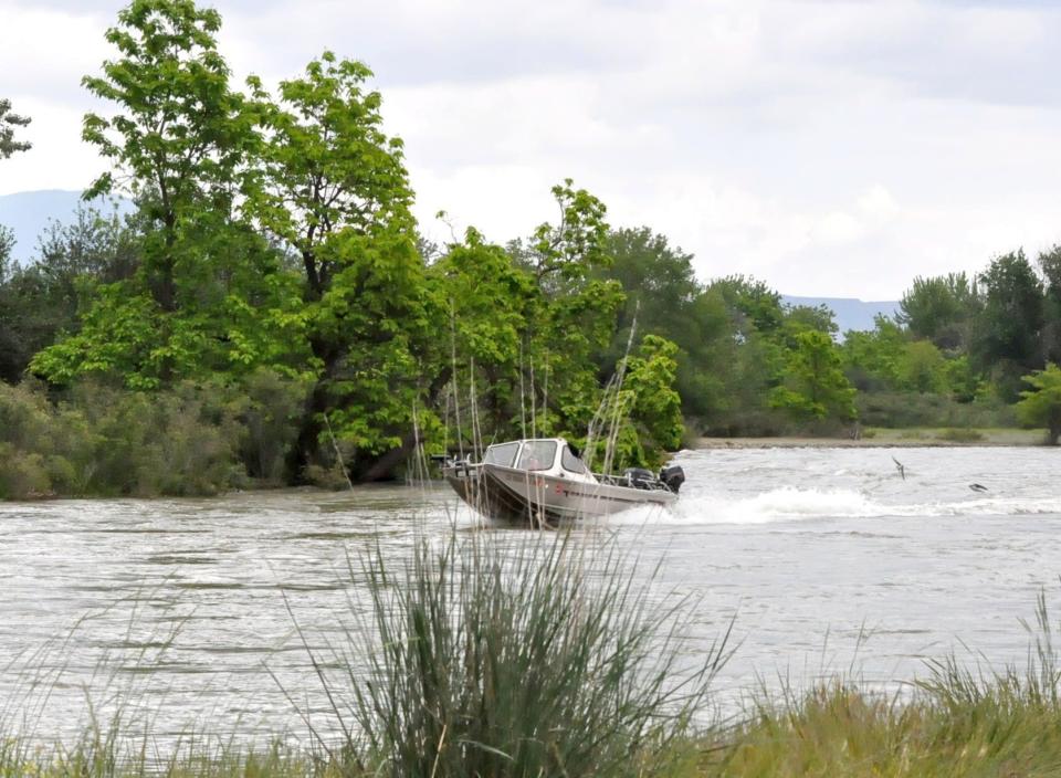 A boat searches an area along the Payette River in Emmett, Idaho, for signs of  21-year-old Everette Jackson of Raceland, who fell into the river while rafting Saturday.