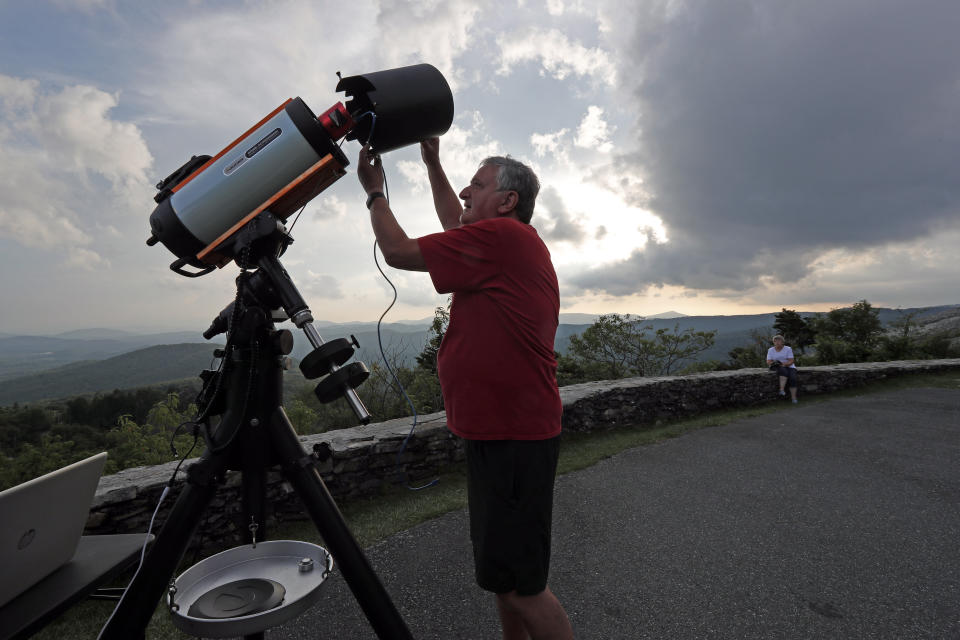 Astrophotographer Johnny Horne sets up his Celestron telescope to photograph Comet NEOWISE at Grandfather Mountain in Linville, N.C., Friday, July 17, 2020. (AP Photo/Gerry Broome)