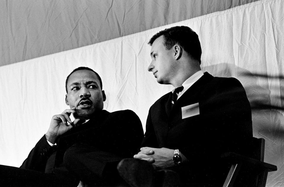 Dr. Martin Luther King Jr., left, talks with an official as he waits to be introduces as the next speaker during the Vanderbilt University's Impact symposium at Memorial Gym on April 7, 1967.