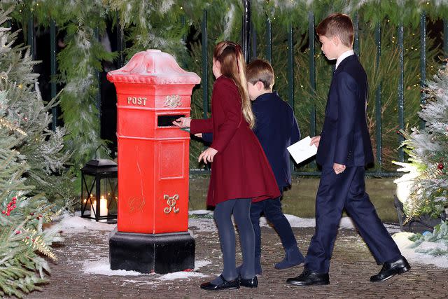 <p>Chris Jackson/Getty</p> Princess Charlotte, Prince Louis and Prince George mail letters for Santa before the Christmas concert on Dec. 8, 2023