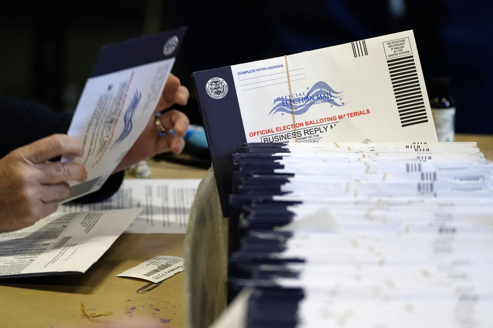 FILE - In this Nov. 4, 2020, file photo, Chester County, Pa. election workers process mail-in and absentee ballots at West Chester University in West Chester. Democrats plan to move quickly on one of the first bills of the new Congress, which would set federal election standards. The For the People Act would require states to offer early voting, same-day registration and the option of absentee voting for all registered voters. (AP Photo/Matt Slocum, File)