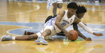 North Carolina's Caleb Love (2) secures a loose ball from College of Charleston's Zep Jasper (12) during the first half of an NCAA college basketball game Wednesday, Nov. 25, 2020, in Chapel Hill, N.C. (Robert Willett/The News & Observer via AP, Pool)