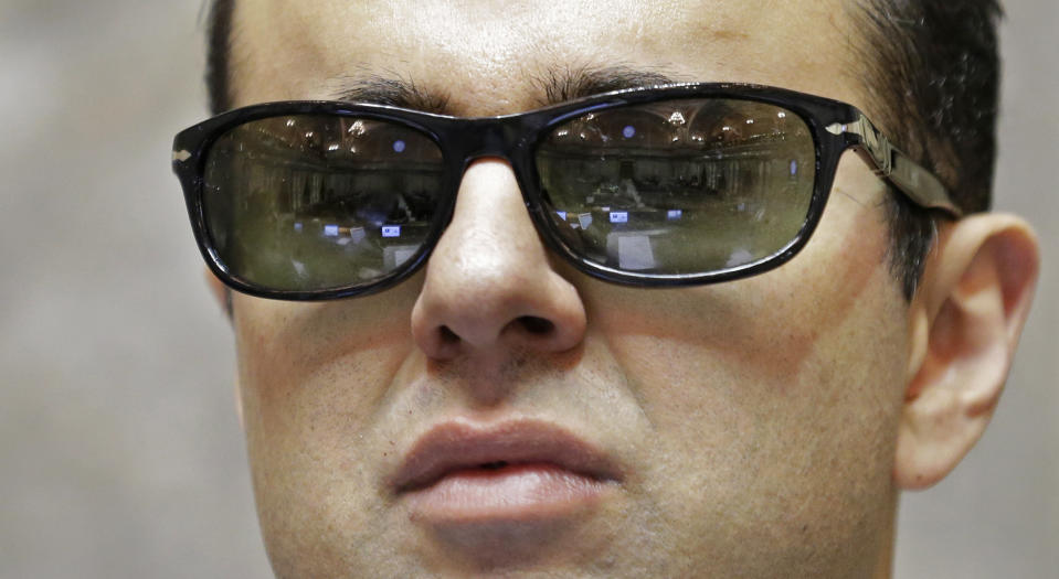 FILE - In this Jan. 5, 2017 file photo, rows of desks in the Washington Senate chamber are reflected in the glasses of Lt. Gov. Cyrus Habib, who is blind, as he stands at the Senate chamber dais at the Capitol in Olympia, Wash. Habib announced on Thursday, March 19, 2020, that he is not running for re-election and will join the Jesuit order of the Catholic Church as he starts the process of becoming a priest. (AP Photo/Ted S. Warren, File)