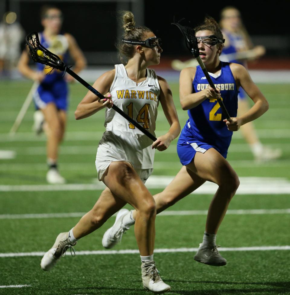 Warwick's Stephanie Malota looks for an open teammate as Queensbury's Kady Duffy covers her during Tuesday's Class B sub-regional game on May 31, 2022.