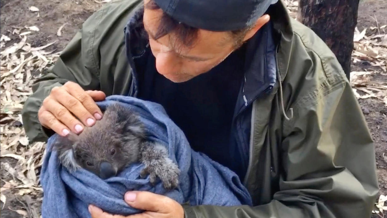 Thron with a koala rescued after the devastating fires in Australia in 2020. (Photo: CuriosityStream)