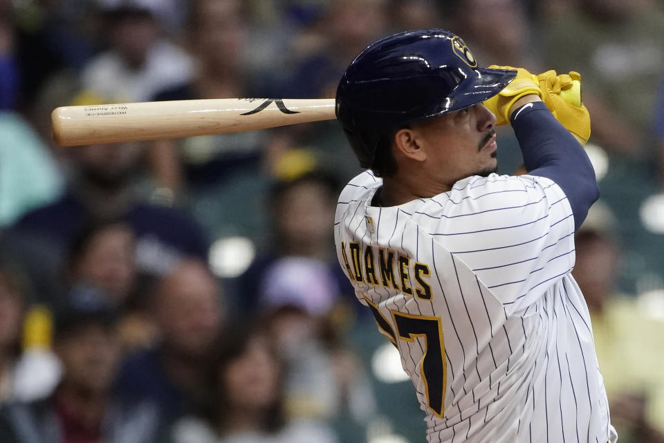 Milwaukee Brewers' Willy Adames watches his two-run home run during the first inning of a baseball game against the Cincinnati Reds, Saturday, Sept. 10, 2022, in Milwaukee. (AP Photo/Aaron Gash)