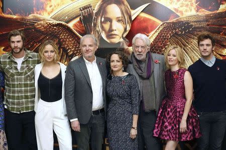 Cast members Liam Hemsworth, Jennifer Lawrence, director Francis Lawrence, producer Nina Jacobson, cast members Donald Sutherland, Elizabeth Banks and Sam Claflin, attend the photocall for 'The Hunger Games: Mockingjay Part 1', in London, November 9, 2014. REUTERS/Paul Hackett