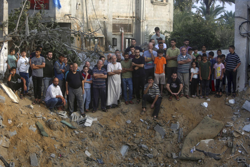 Palestinians inspect the damage of a destroyed house that was hit by an Israeli airstrike in town of Khan Younis, southern Gaza Strip, Tuesday, Oct. 24, 2023. (AP Photo/Mohammed Dahman)