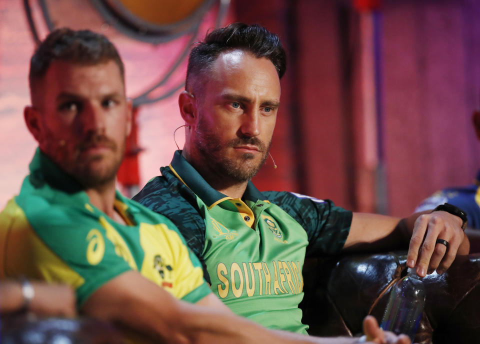 South Africa's Faf du Plessis, background and Australia's Aaron Finch are seated, during the Captains' Press Conference, in London, Thursday, May 23, 2019. The Cricket World Cup starts on Thursday May 30. (Andrew Boyers/Pool Photo via AP)