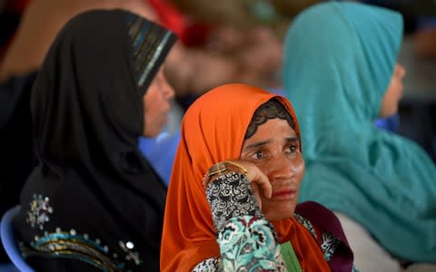 Cambodian-Muslim women attend the verdict  - Credit: TANG CHHIN SOTHY/AFP