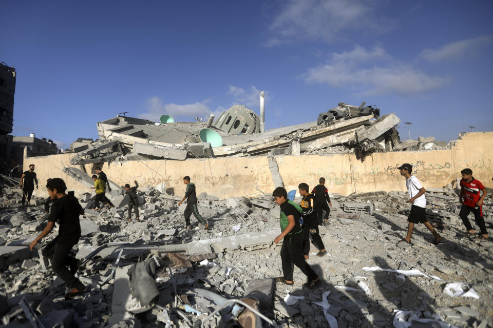 Palestinians inspect the damage of a destroyed mosque following an Israeli airstrike in Khan Younis refugee camp, southern Gaza Strip, Wednesday, Nov. 8, 2023. (AP Photo/Mohammed Dahman)