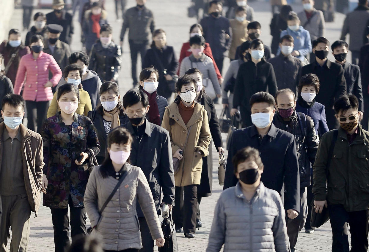 People wearing protective face masks commute amid concerns over the new coronavirus disease (COVID-19) in Pyongyang, North Korea March 30, 2020. (Kyodo/via Reuters)