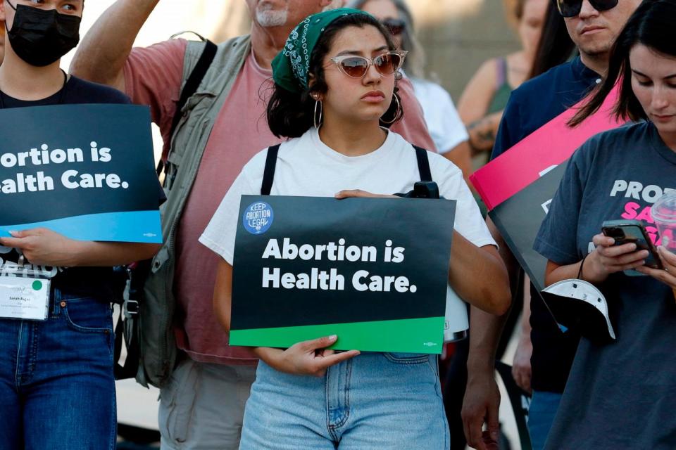PHOTO: A woman holds a 'Abortion is Health Care' sign as abortion rights activists rally outside the Lloyd D. George Federal Courthouse in protest of the overturning of Roe Vs. Wade by the Supreme Court, in Las Vegas, June 24, 2022.  (Ronda Churchill/AFP via Getty Images)