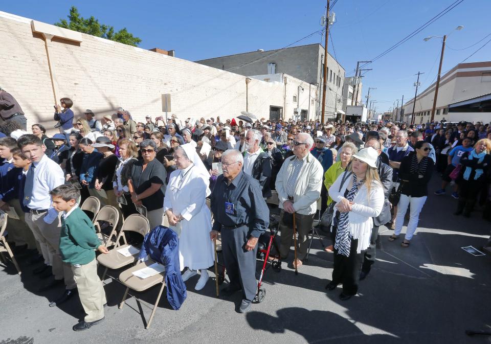 Hundreds gather to hear Boston Archdiocese Cardinal Sean O'Malley leads mass, Tuesday, April 1, 2014, along the international border wall in Nogales, Ariz. O'Malley and a delegation of Roman Catholic leaders were visiting the border town to bring awareness to immigration reform and to remember those who have died trying to cross the border in years past. (AP Photo/Matt York)