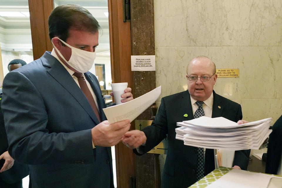 FILE - This March 2, 2021 photo shows Mississippi Senate Finance Committee Chairman Josh Harkins, left, reviewing a number of proposed bills with Senate Accountability Efficiency and Transparency Committee Chairman John Polk at the Capitol in Jackson, Miss. Responding to concerns from state officials, the U.S. Treasury Department said Wednesday, March 17, 2021 that states can cut taxes without penalty under a new federal pandemic relief law — so long as they use their own funds to do so. (AP Photo/Rogelio V. Solis, file)