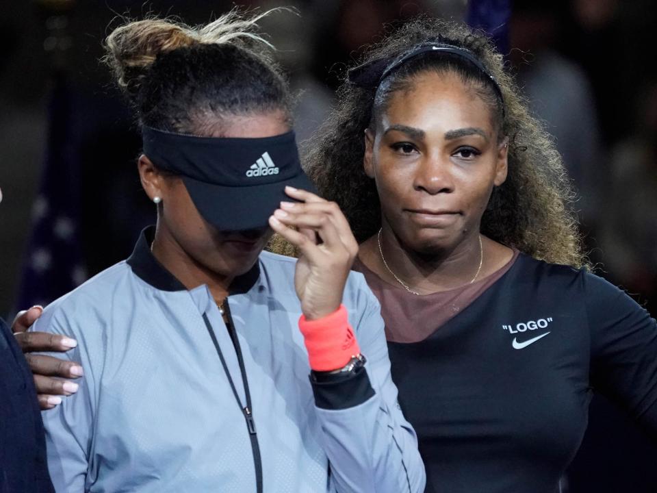 An emotional Serena Williams (right) stands beside Naomi Osaka following the controversy of the 2018 US Open final.