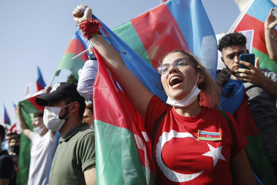 Demonstrators holding Azerbaijan flags chant slogans during a protest supporting Azerbaijan, in Istanbul, Sunday, Oct. 4, 2020. Armenian and Azerbaijani forces continue their fighting over the separatist region of Nagorno-Karabakh, following the reigniting of a decades-old conflict. Turkey, which strongly backs Azerbaijan, has condemned an attack on Azerbaijan's second largest city Gence and said the attack was proof of Armenia's disregard for law. (AP Photo/Emrah Gurel)