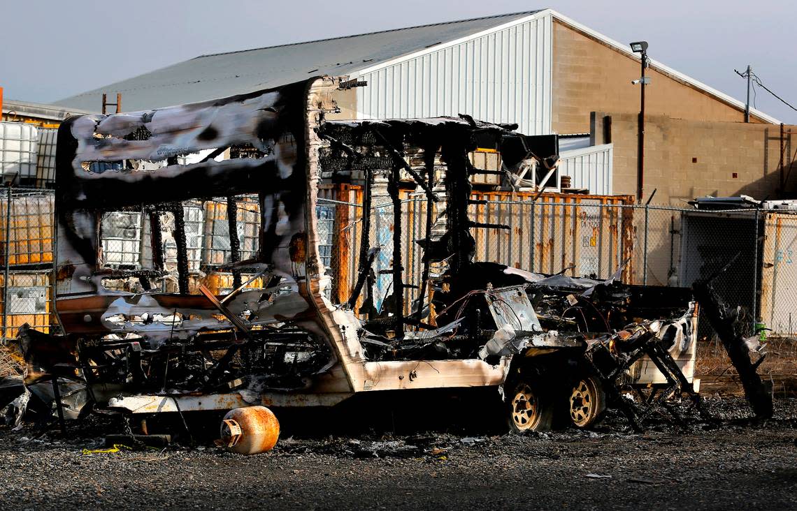 Burnt out shell of a travel trailer abandoned on the shoulder of Railroad Avenue near other motorhomes and trailers in downtown Kennewick on February 6, 2023