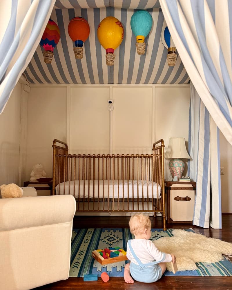 Baby sitting on floor on nursery with newly installed tent area.