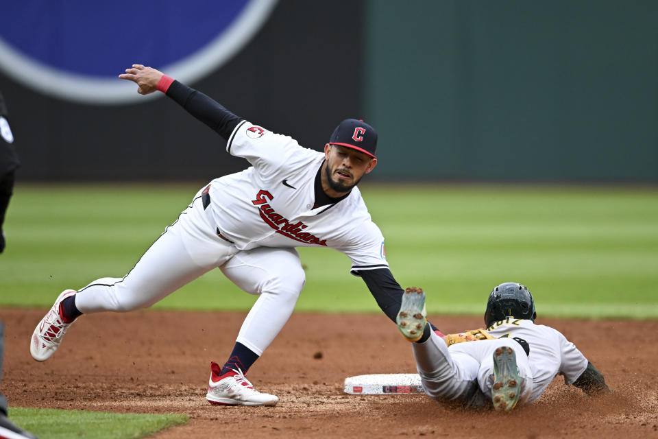 Oakland Athletics' Esteury Ruiz is caught stealing second base by Cleveland Guardians' Gabriel Arias during the third inning of a baseball game Saturday, April 20, 2024, in Cleveland. (AP Photo/Nick Cammett)