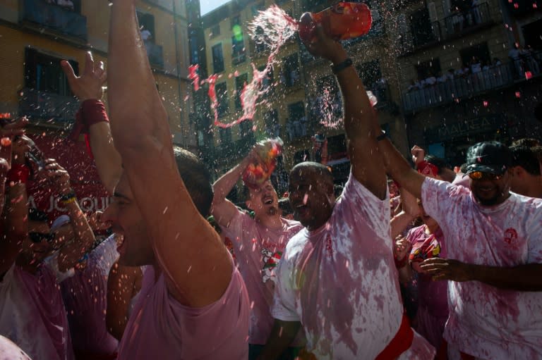 People throw wine during the 'Chupinazo' (start rocket) marking the kickoff of the San Fermin Festival in Pamplona, northern Spain, on July 6, 2016