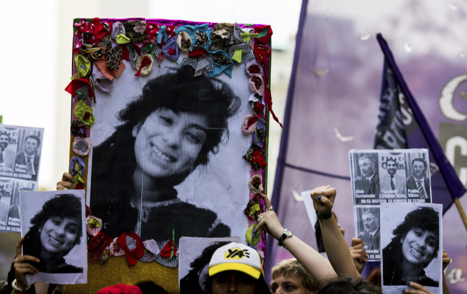 Demonstrators hold posters that show gender violence victim Lucia Perez, 16, during a protest in Buenos Aires, Argentina, on Wednesday, Dec. 5, 2018. Argentine feminist groups and labor unions gathered to protest the court ruling that acquitted two men accused of sexually abusing and killing the teen. The ruling said that the girl had consensual sex with one of the men and that she died of an overdose. (AP Photo/Tomas F. Cuesta)