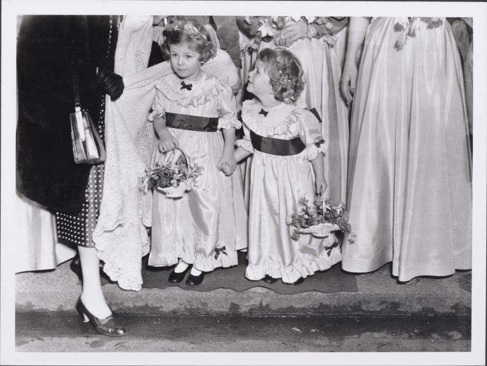 Camilla, aged four, and her sister Annabelle, aged three, as bridesmaids for the wedding of Jeremy Gubbitt and Diana du Cane in 1952 (Getty Images)
