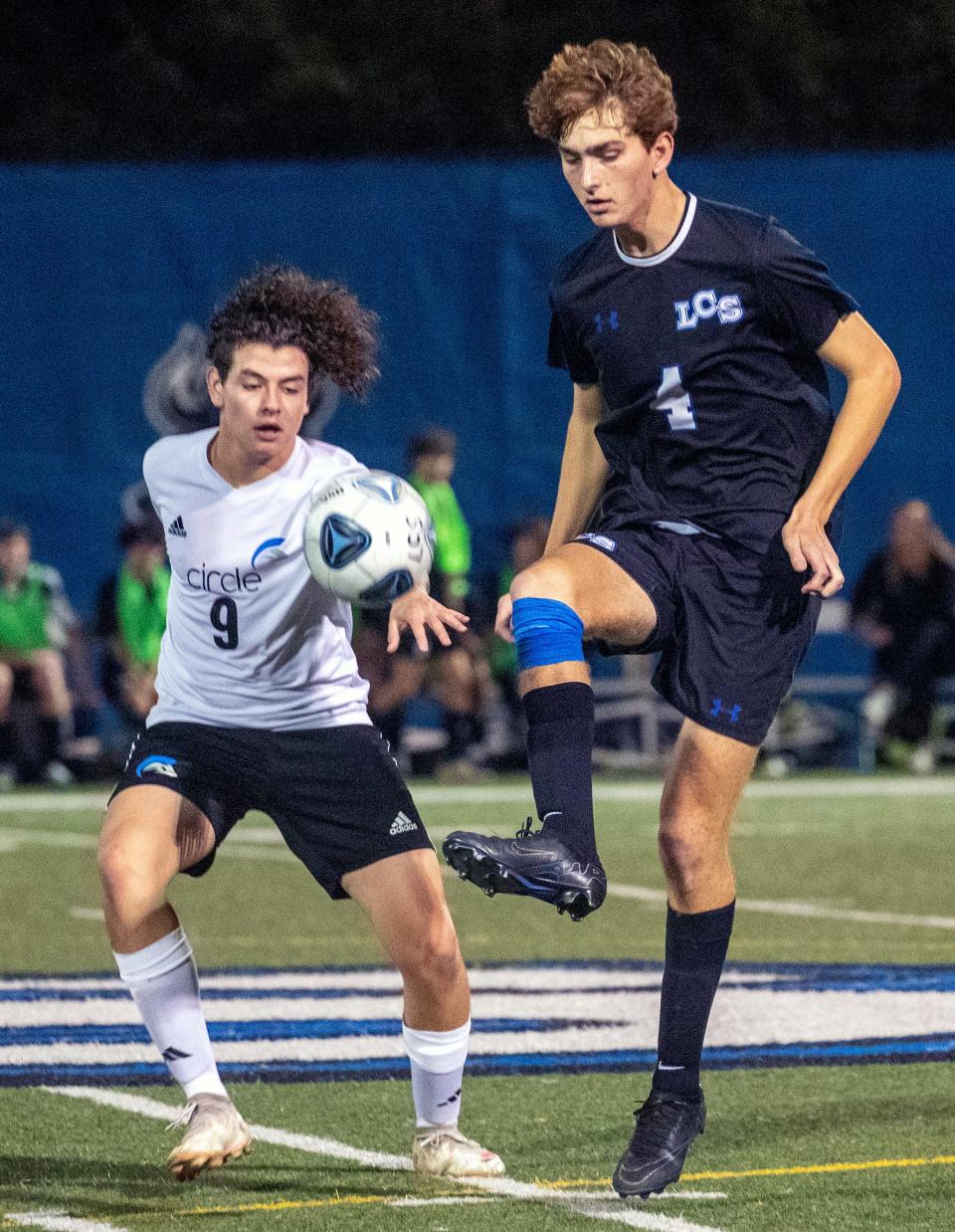 Lakeland Christian's Henry Strawbridge controls the ball in front of Circle Christian's Micaiah Smith on Friday night in the Class 2A, Region 7 semifinals at Viking Stadium.