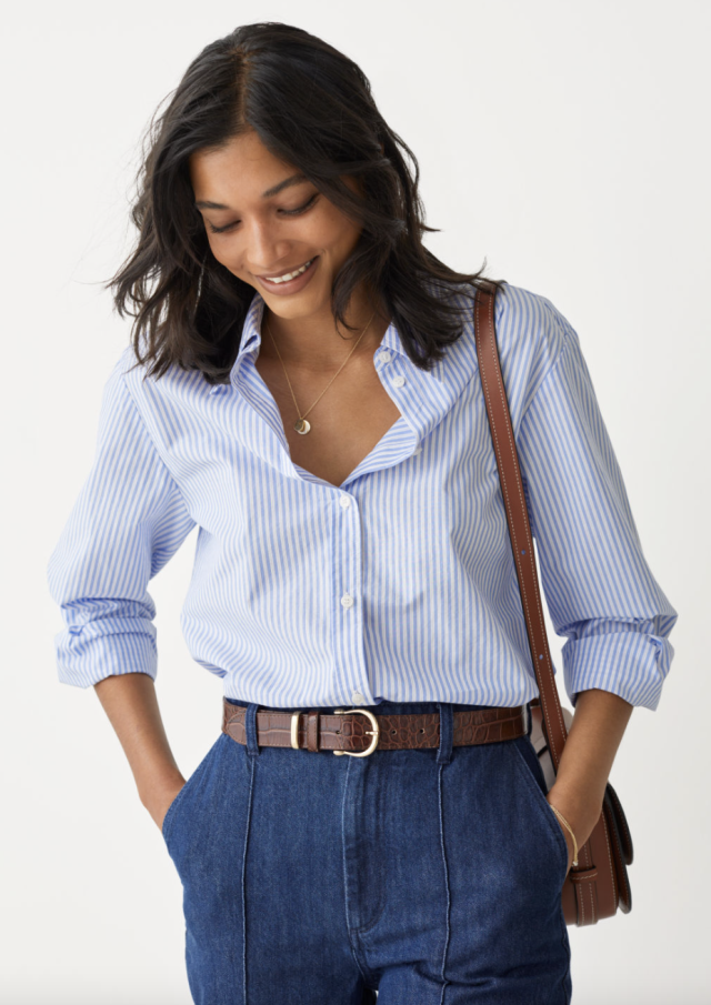 model in jeans, brown belt and blue stripped Classic Cotton Shirt (Photo via & Other Stories)