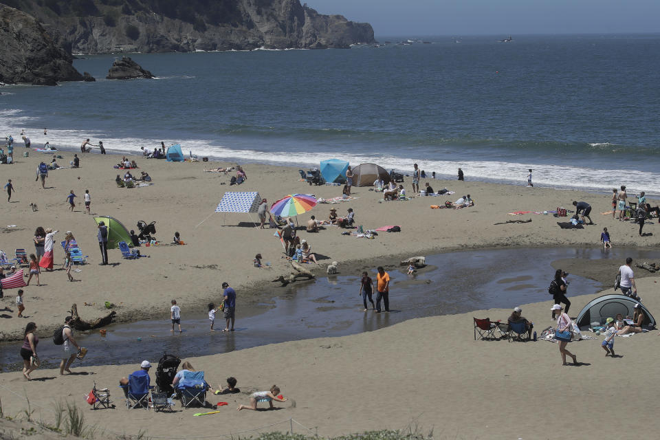 People visit Baker Beach during the coronavirus outbreak in San Francisco, Sunday, May 24, 2020. (AP Photo/Jeff Chiu)