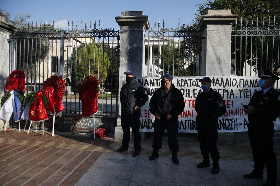 Police stand guard outside the Athens Polytechnic in the Greek capital on Monday, Nov. 16, 2020. The government has banned an annual rally to mark the anniversary of Nov. 17, 1973 uprising by Polytechnic students against the military dictatorship that then ruled the country and collapsed the following year. Left-wing opposition parties have criticized the decision taken due to the pandemic and vowed to defy the ban. (AP Photo/Thanassis Stavrakis)