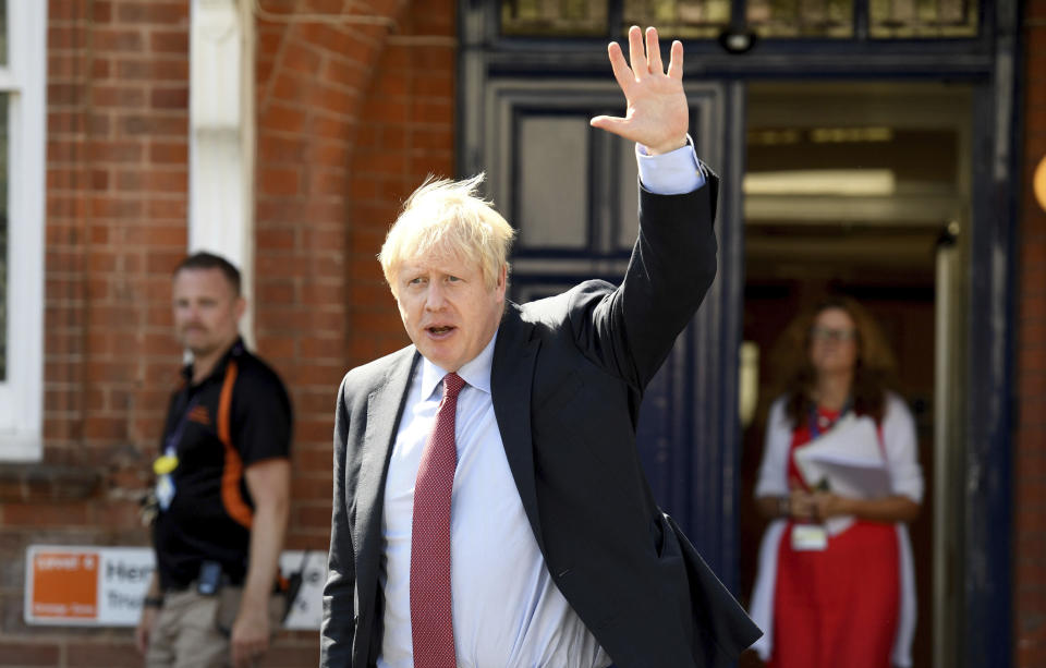 Britain's Prime Minister Boris Johnson leaves after a visit to Torbay Hospital, south England Friday Aug. 23, 2019, after he welcomed a review into hospital food. (Finnbarr Webster/Pool via AP)