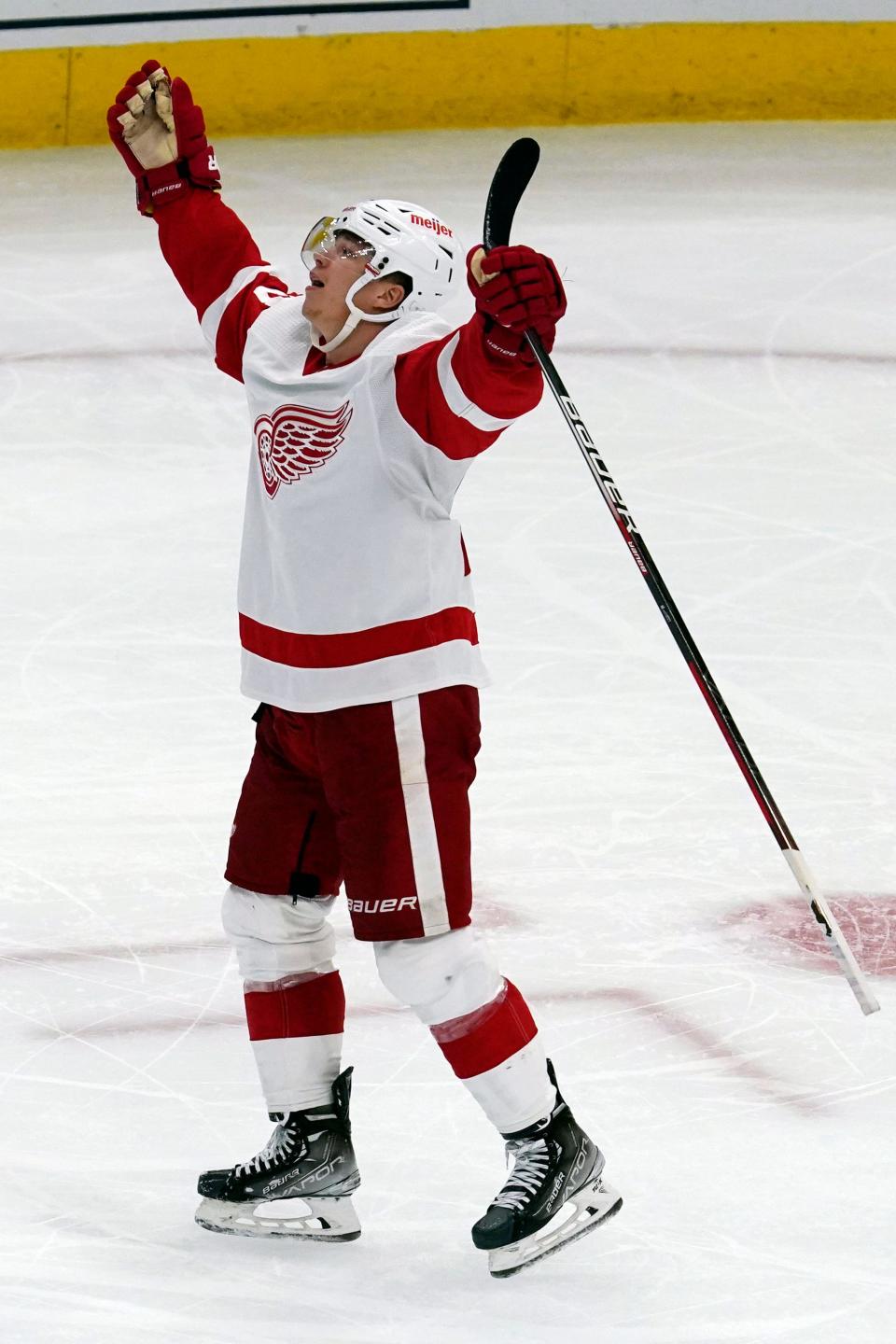 Red Wings left wing Lucas Raymond celebrates his hat trick against the Blackhawks during the third period of the 6-3 win in Chicago on Sunday, Oct. 24, 2021.